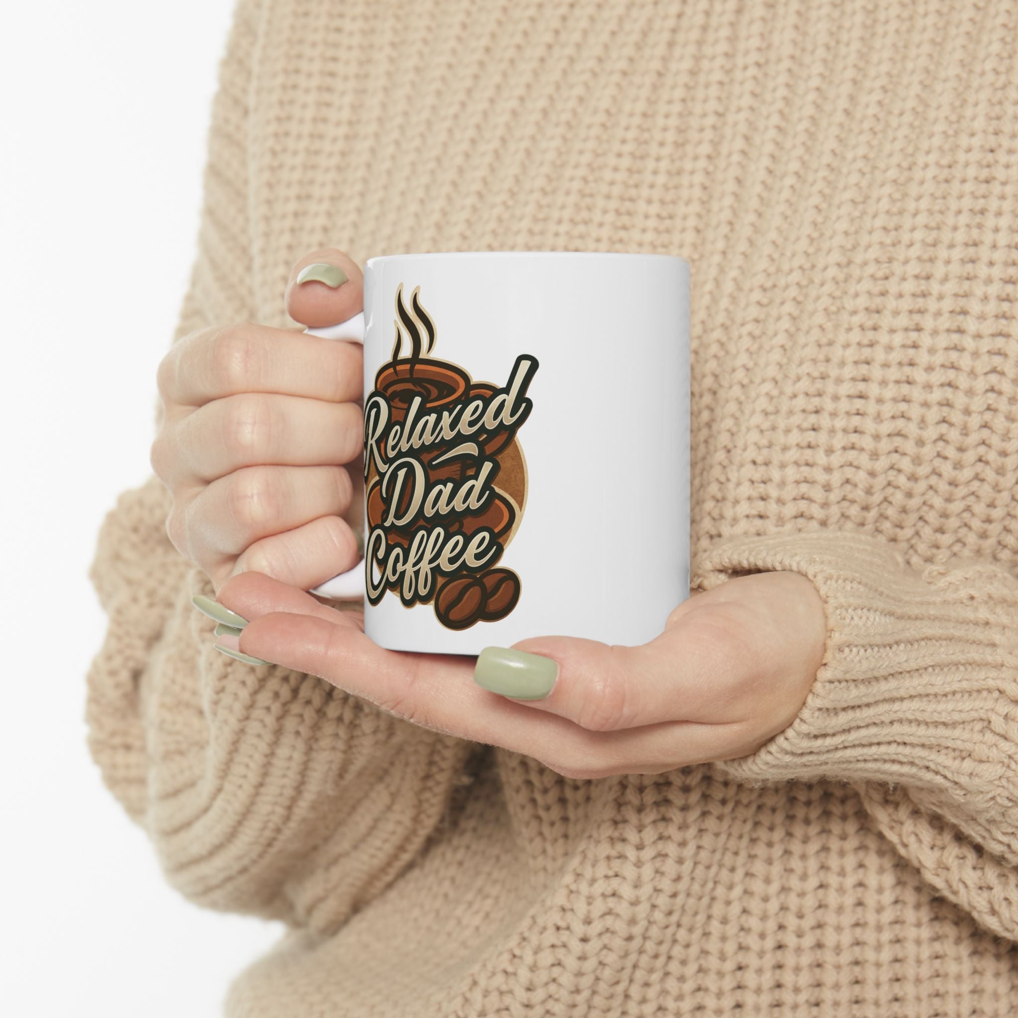 Person in beige knit sweater holding white coffee mug with Relaxed Dad Coffee design