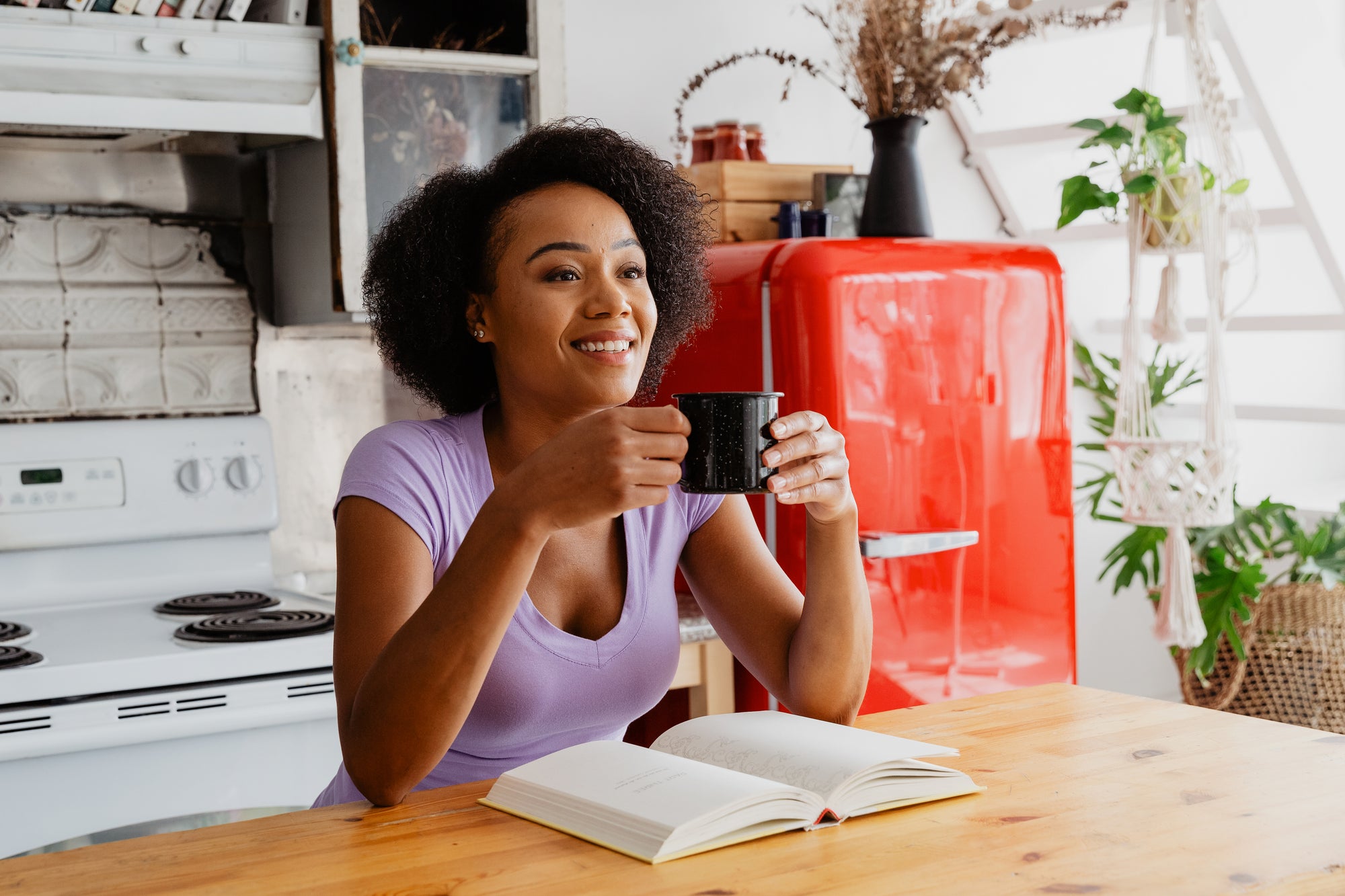 Woman drinking Relaxed Dad Coffee in kitchen